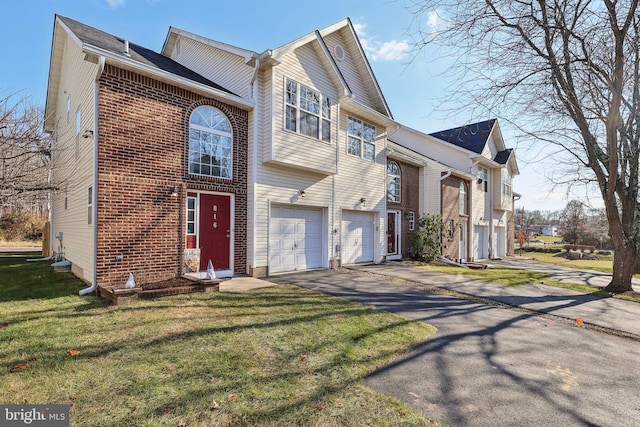 view of front of property with a front lawn and a garage