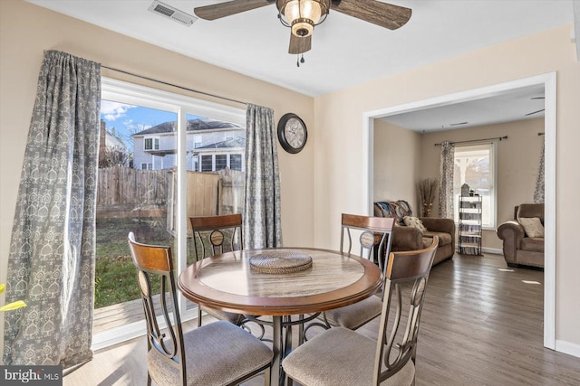 dining area featuring ceiling fan, wood-type flooring, and a wealth of natural light