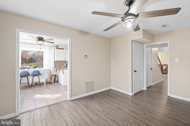 spare room featuring hardwood / wood-style flooring and ceiling fan