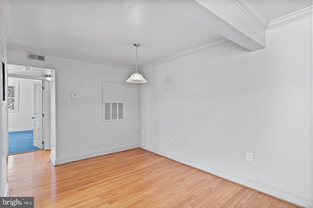 empty room with light hardwood / wood-style flooring and ornamental molding