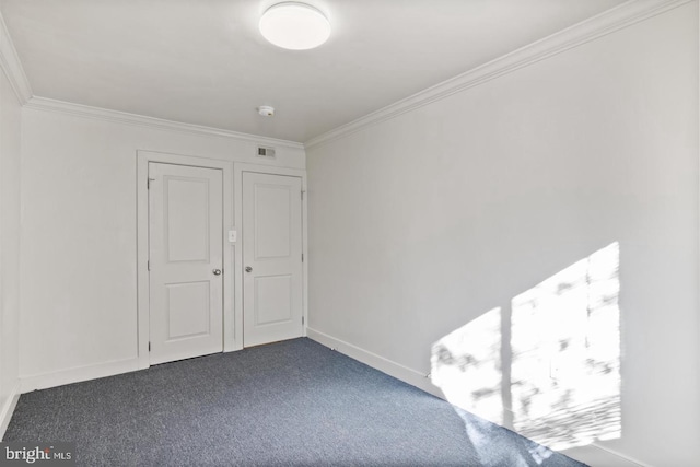 interior space with dark colored carpet and ornamental molding