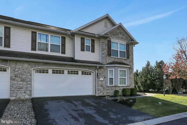 view of front of property featuring a garage and a front lawn