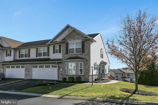 view of front of house with a garage and a front yard