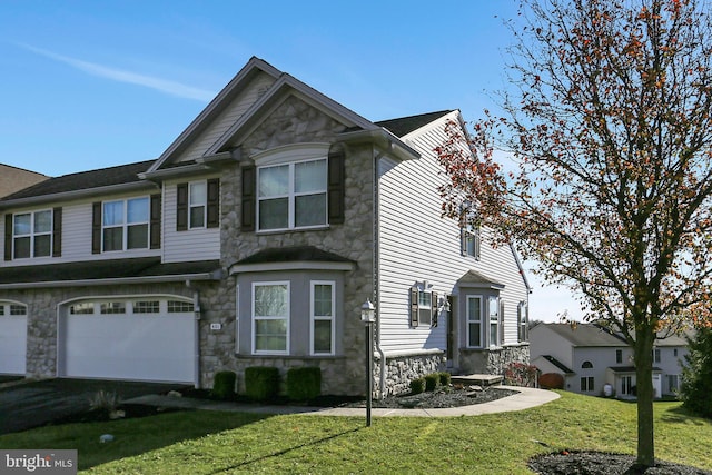 view of front of property with a front yard and a garage