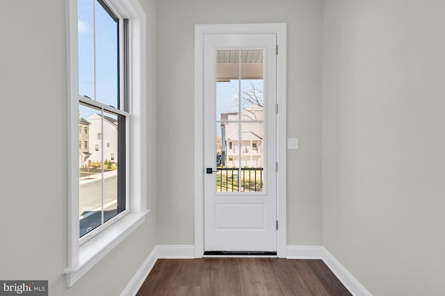 entryway featuring dark wood-type flooring and baseboards