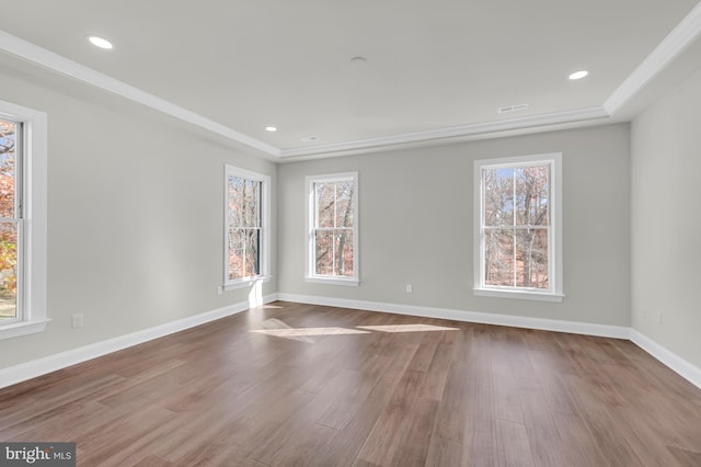 unfurnished room featuring recessed lighting, plenty of natural light, baseboards, and wood finished floors