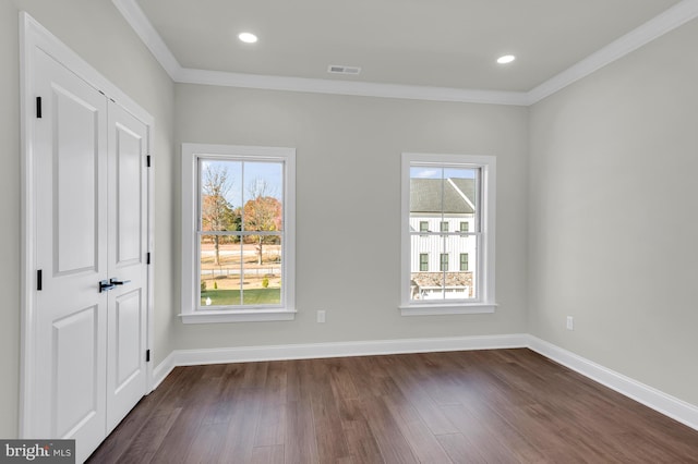 unfurnished bedroom featuring multiple windows, visible vents, and baseboards