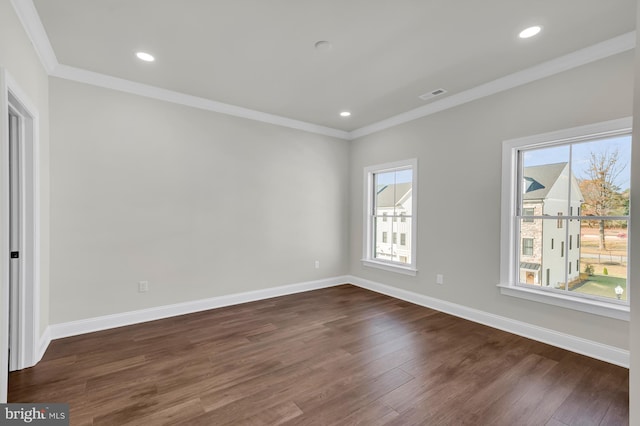 unfurnished room featuring baseboards, visible vents, dark wood-style floors, crown molding, and recessed lighting