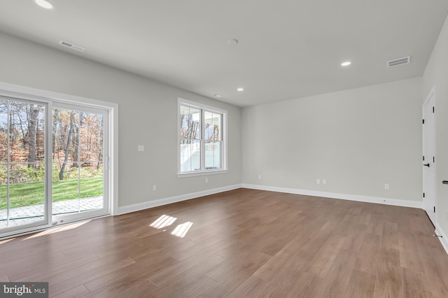 interior space featuring baseboards, visible vents, and light wood finished floors