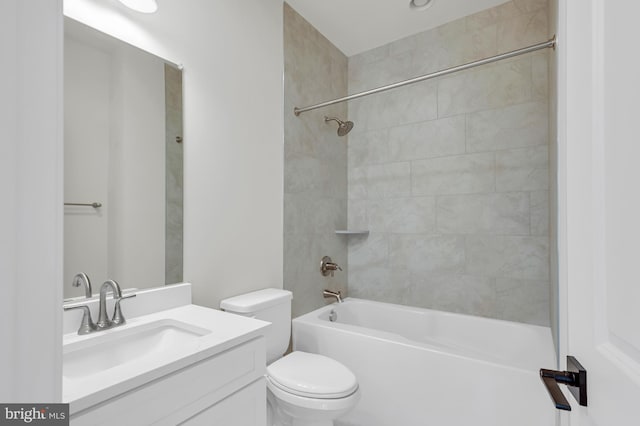 full bathroom featuring washtub / shower combination, vanity, and toilet