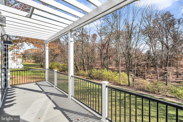 wooden deck featuring a yard and a pergola