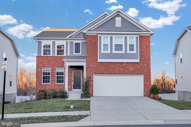 view of front of house with a front yard and a garage