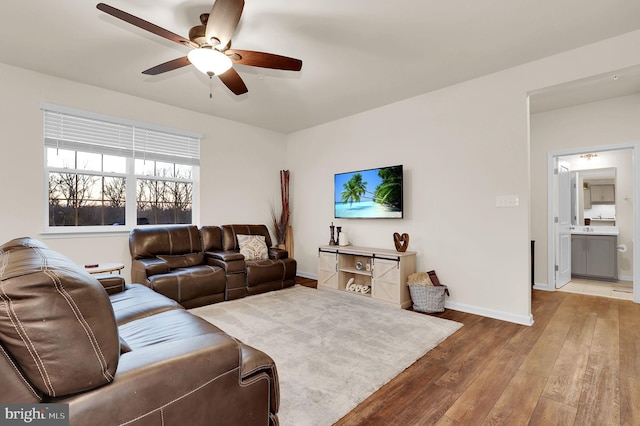 living room with hardwood / wood-style floors and ceiling fan