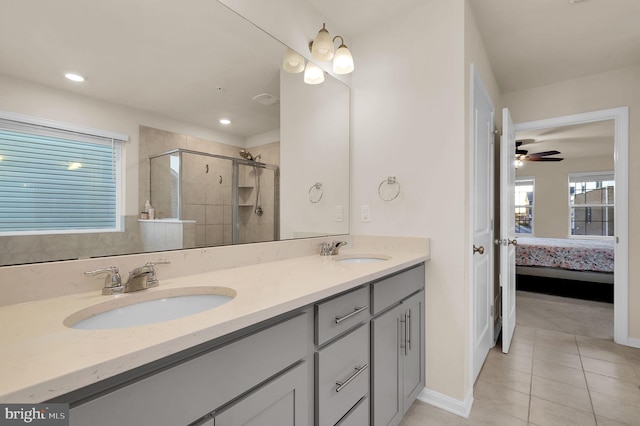 bathroom with tile patterned flooring, ceiling fan, a shower with shower door, and vanity