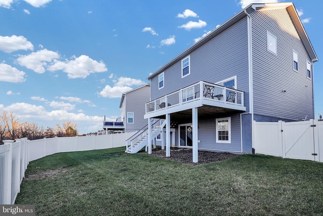 back of property with a lawn and a deck