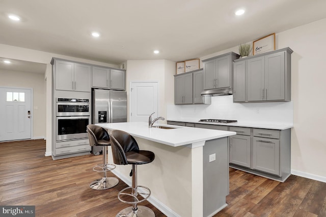 kitchen with dark hardwood / wood-style flooring, sink, gray cabinets, and appliances with stainless steel finishes