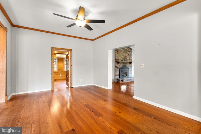 unfurnished living room featuring ceiling fan, crown molding, and wood-type flooring