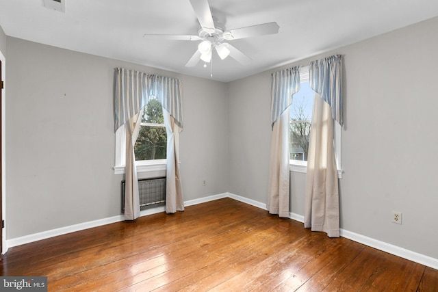 spare room featuring ceiling fan, plenty of natural light, and hardwood / wood-style flooring