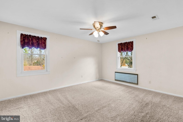 unfurnished room with ceiling fan and carpet