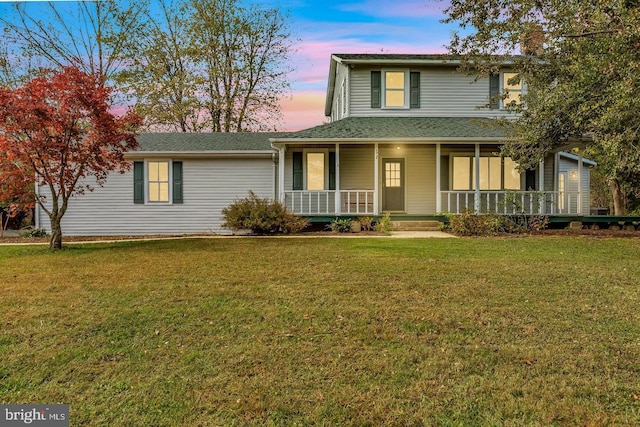 view of front of house with a lawn and a porch