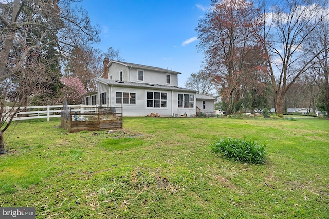 rear view of house with a lawn