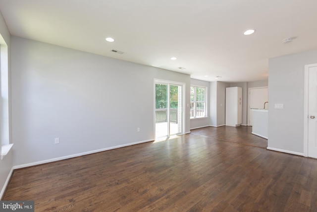 empty room featuring dark hardwood / wood-style flooring