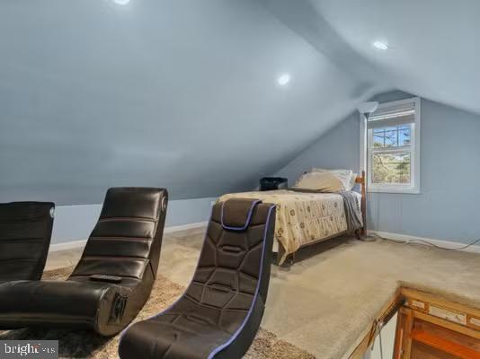 carpeted bedroom with vaulted ceiling