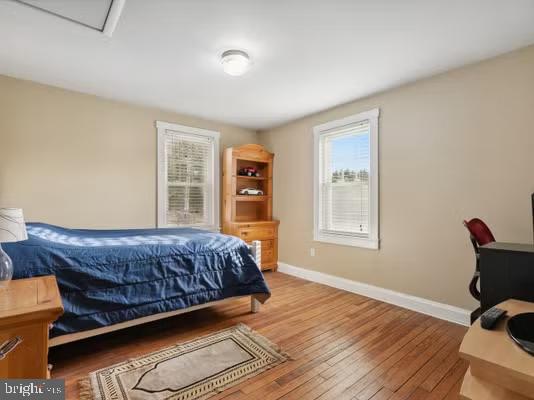 bedroom with hardwood / wood-style flooring