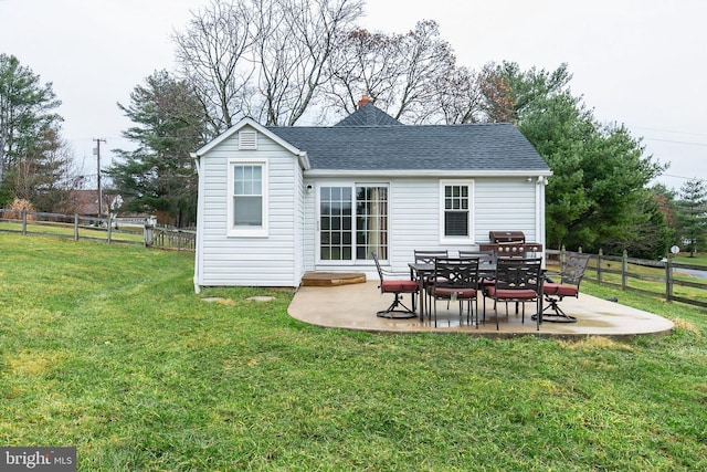 back of property with a lawn and a patio area