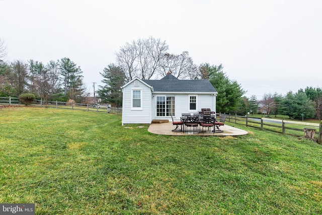 back of house featuring a lawn and a patio area