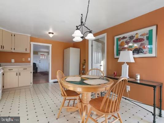 dining space featuring a notable chandelier