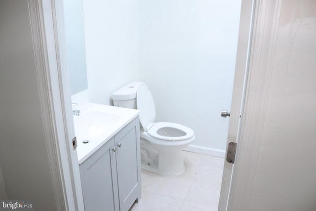 bathroom with tile patterned flooring, vanity, and toilet