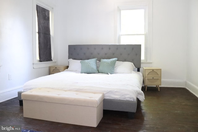 bedroom with dark hardwood / wood-style floors