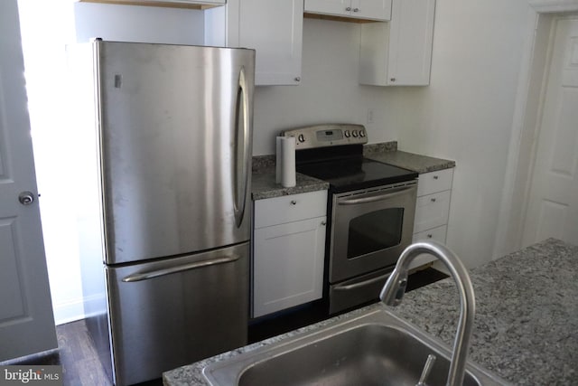 kitchen with white cabinetry, sink, dark wood-type flooring, and appliances with stainless steel finishes