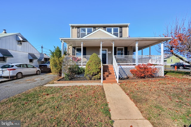 view of front of house with a porch and a front lawn