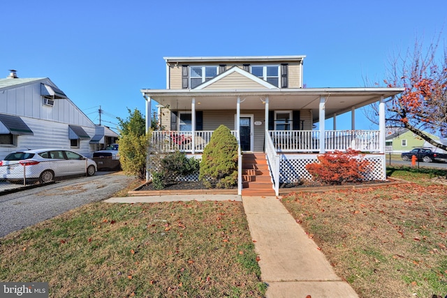 view of front of house featuring a front lawn and covered porch