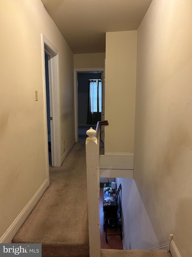 hallway with light colored carpet