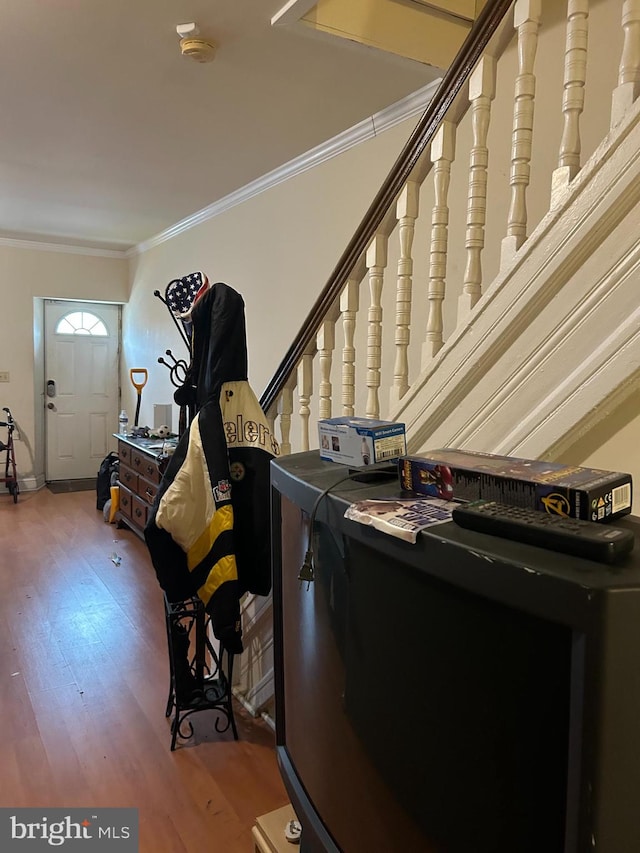 interior space featuring hardwood / wood-style flooring and ornamental molding