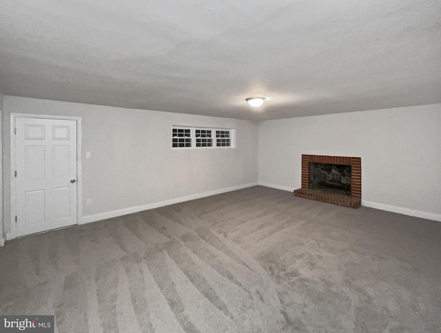 unfurnished living room featuring a fireplace and carpet