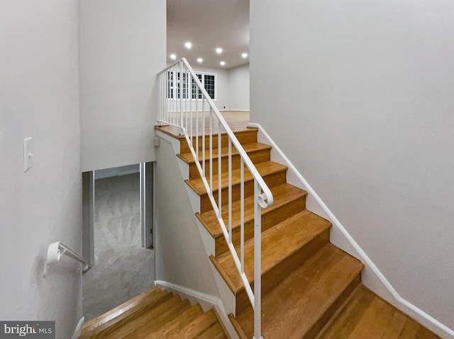 staircase featuring wood-type flooring