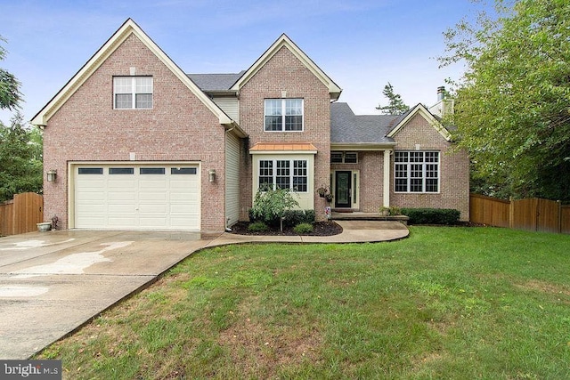 view of front of home with a front lawn and a garage