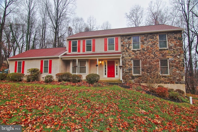 colonial inspired home featuring covered porch