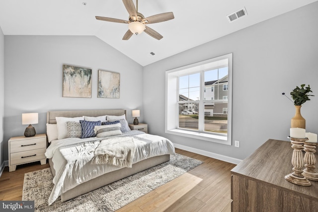 bedroom featuring light wood-type flooring, ceiling fan, and lofted ceiling