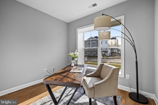 office area with a wealth of natural light and hardwood / wood-style flooring