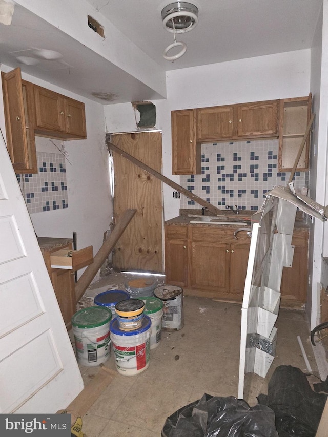 kitchen with decorative backsplash and sink