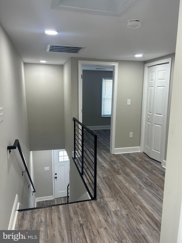 stairs featuring hardwood / wood-style floors