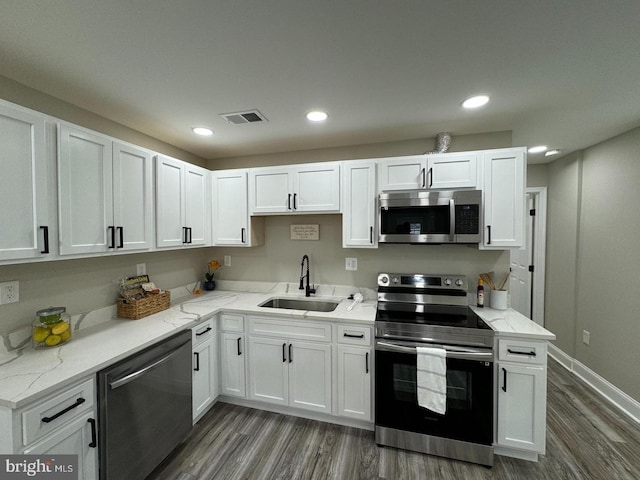 kitchen featuring white cabinets, dark hardwood / wood-style flooring, sink, and appliances with stainless steel finishes