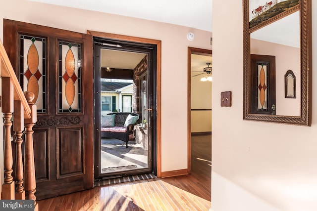 entryway featuring hardwood / wood-style floors, vaulted ceiling, and ceiling fan