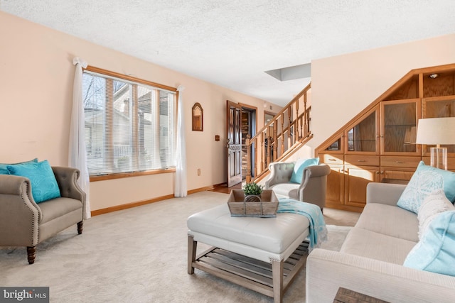 carpeted living room featuring a textured ceiling