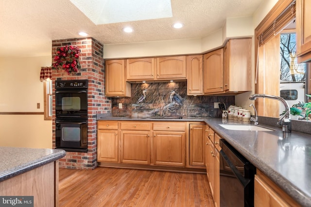 kitchen with decorative backsplash, light wood-type flooring, a textured ceiling, sink, and black appliances